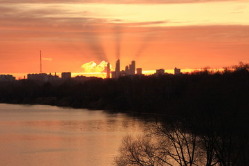 Golden dawn in the city over the river