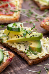 Sandwiches with cream cheese, vegetables and salami.