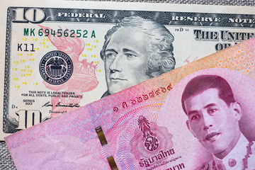 American dollar and Thai baht closeup.  Currency exchange rate.