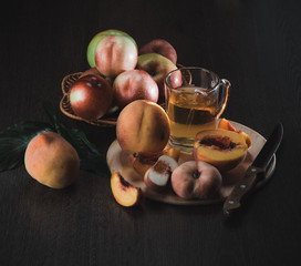 Fototapeta na wymiar Still life of peaches and juice on a dark background