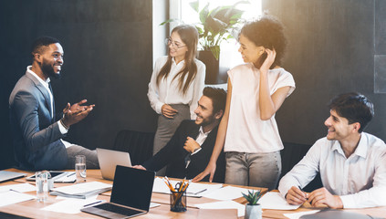 Business people having break and talking at meeting
