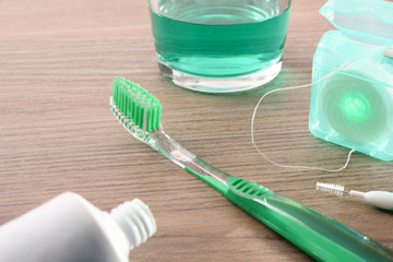 Dental hygiene tools on wood table elevated view close up