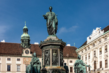 Austria, Vienna, Hofburg Palace, In der Burg: Famous emperor Francis statue and Austrian National Library facade at Josefsplatz in the city center of the capital with blue sky - concept Habsburg