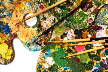 Palette with colorful paints. Colorful oil painting palette with a brush reaching in. Paint brushes and paints for drawing. tulip on a white background