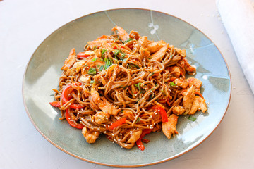 Buckwheat noodles with vegetables and chicken breast in the sauce teriyaki