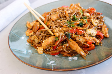 Buckwheat noodles with vegetables and chicken breast in the sauce teriyaki