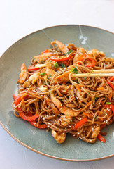 Buckwheat noodles with vegetables and chicken breast in the sauce teriyaki