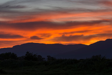 Stunning sunset over Old mountain, Bulgaria. View to Botev peak in the far distance. Landscape, travel concept.