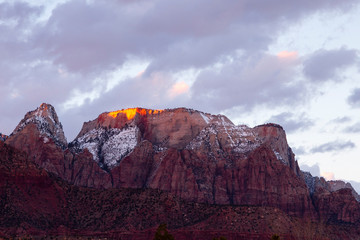 Colourful sunset mountain peaks and beautiful cloudy sky view in Springdale, near Zion National Park, Utah, USA, at dusk