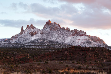 View of pretty mountain with several peaks covered in dusting of snow in Springdale at dusk, near Zion National Park, Utah, USA