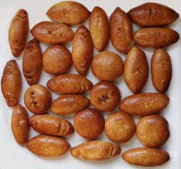 A lot of Russian traditional pies with filling on a white background