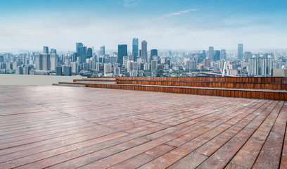 Naklejka premium Urban skyscrapers with empty square floor tiles