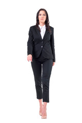 Displeased bossy business female ceo walking towards camera. Full body isolated on white background.