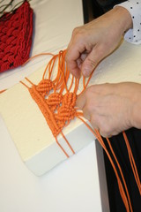 Women's hands weave macrame