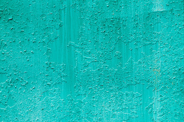 Imperfect metallic plate. Cracked paint close-up. Damage texture in macro. Grungy metal panel. Textured background. Rough faded uneven iron wall. Obsolete surface. Peeling of old paint. Flaking of dye