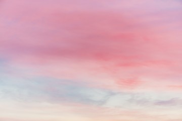 Sunset sky with multicolor light clouds. Colorful smooth sky gradient. Natural background of sunrise. Amazing heaven at morning. Slightly cloudy evening atmosphere. Wonderful weather. Pink dawn clouds