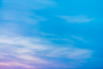 Sunset sky with pink lilac light clouds. Colorful smooth blue white sky gradient. Natural sunrise background. Amazing heaven at morning. Slightly cloudy evening atmosphere. Wonderful weather on dawn.