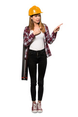 A full-length shot of a Architect woman frightened and pointing to the side over isolated white background