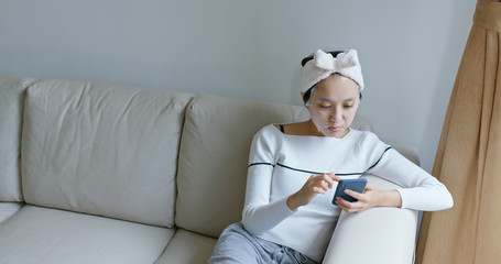 Woman use of paper mask with cellphone