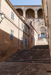 Obraz premium empty narrow dark street in an ancient, historic city; buildings and street in brown tones