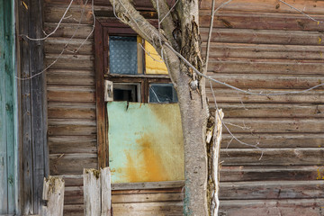 window in an abandoned house, partially clogged with plywood