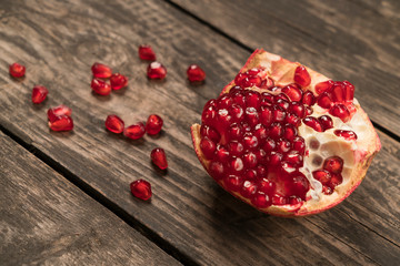 red pomegranate on a wooden table close-up