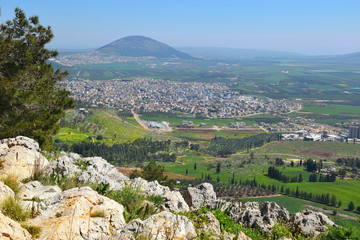 views of the Jezreel Valley and Mount Tabor from the heights of Mount Precipice, located just...