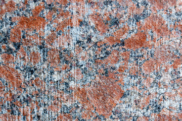 Natural mountain red granite background with impregnation of minerals