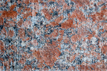Natural mountain red granite background with impregnation of minerals