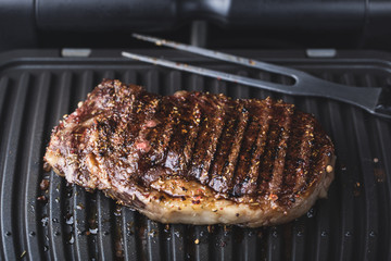 Roasted steak meat on grill grid