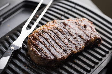 Roasted steak meat on grill grid