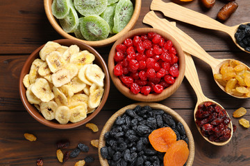 Flat lay composition with different dried fruits on wooden background. Healthy lifestyle