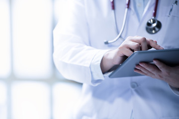 Medical doctor using smart tablet for work in hospital