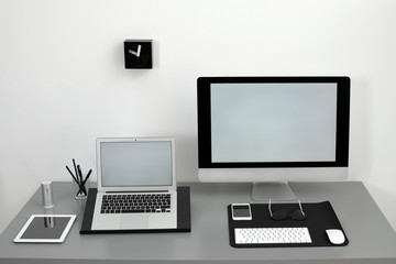 Modern workplace interior with computers on table. Space for text