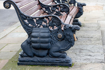 Famous camel bench in London with a kneeling camel with gold ornamentation holding up a bench