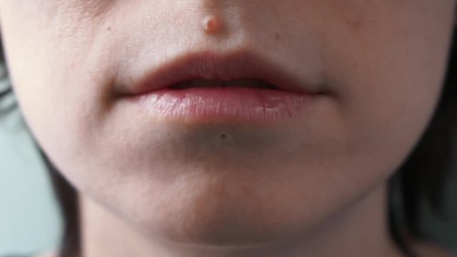 girl's mouth saying "I'm very sorry" close up