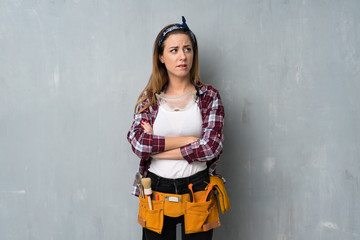 Craftsmen or electrician woman with confuse face expression while bites lip