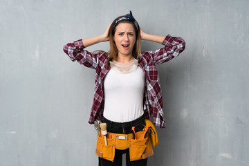 Craftsmen or electrician woman frustrated and takes hands on head