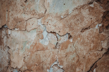 Retro abstract closeup of brown ruined wall. Brown cement concrete stucco. Brown stucco wall background grungy texture. Cracks in the wall.
