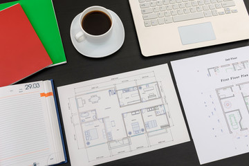 House project with laptop and coffee cup on black