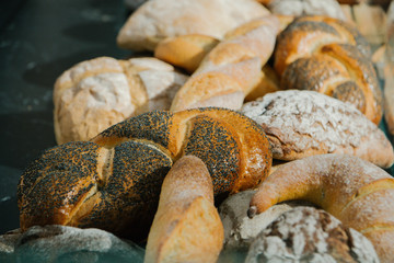 different fresh bread on the shelves in bakery. Selective focus