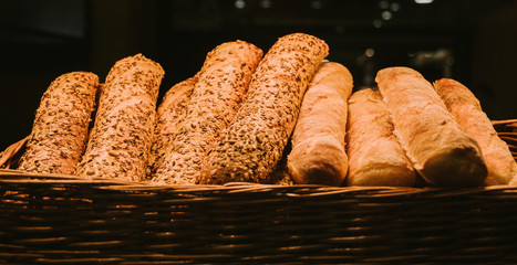 different fresh bread on the shelves in bakery. Selective focus