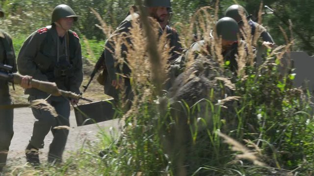 Soldiers bring a anti tank gun in position