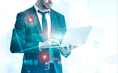 Businessman with laptop, binary code and hud