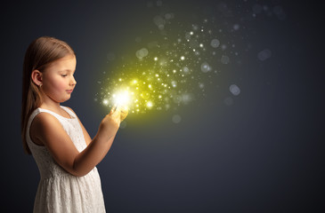 Little cute girl playing on sparkling tablet
