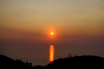 Sea, sky, sunset on horizon of mediterranean coast. Amazing sunset vibes on edge ocean. Sunrise over sea. Beautiful view, landscape and natural environment. Summer season, travel, vacation, holiday.