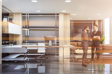 Businessmen talking in office with lounge