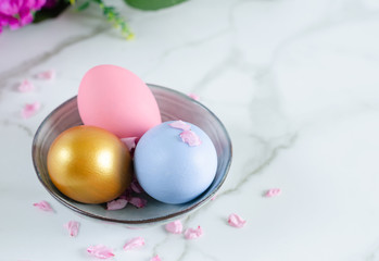 Colorful easter eggs in ceramic bowl.