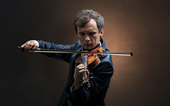 Lonely violinist composing on cello with nothing around
