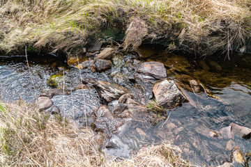 Stones in running water in a mountain river stream